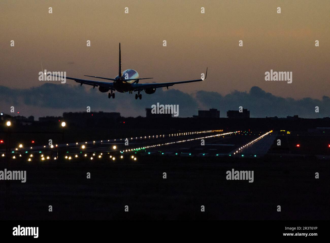 plane at sunset landing at Palma airport, mallorca, balearic islands ...