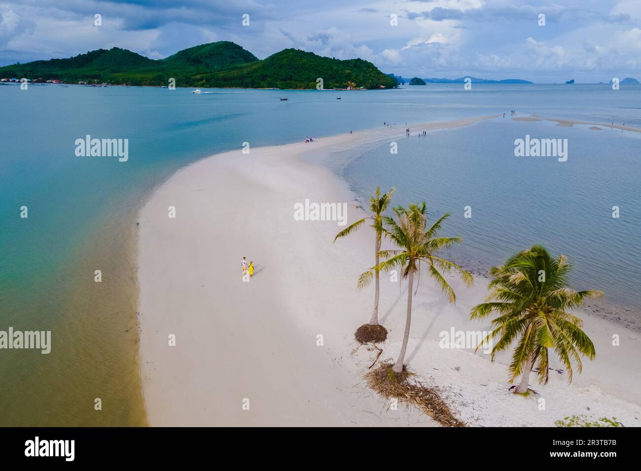 Men and women on the beach of Koh Yao Yai Island Thailand, beach with white sand and palm trees