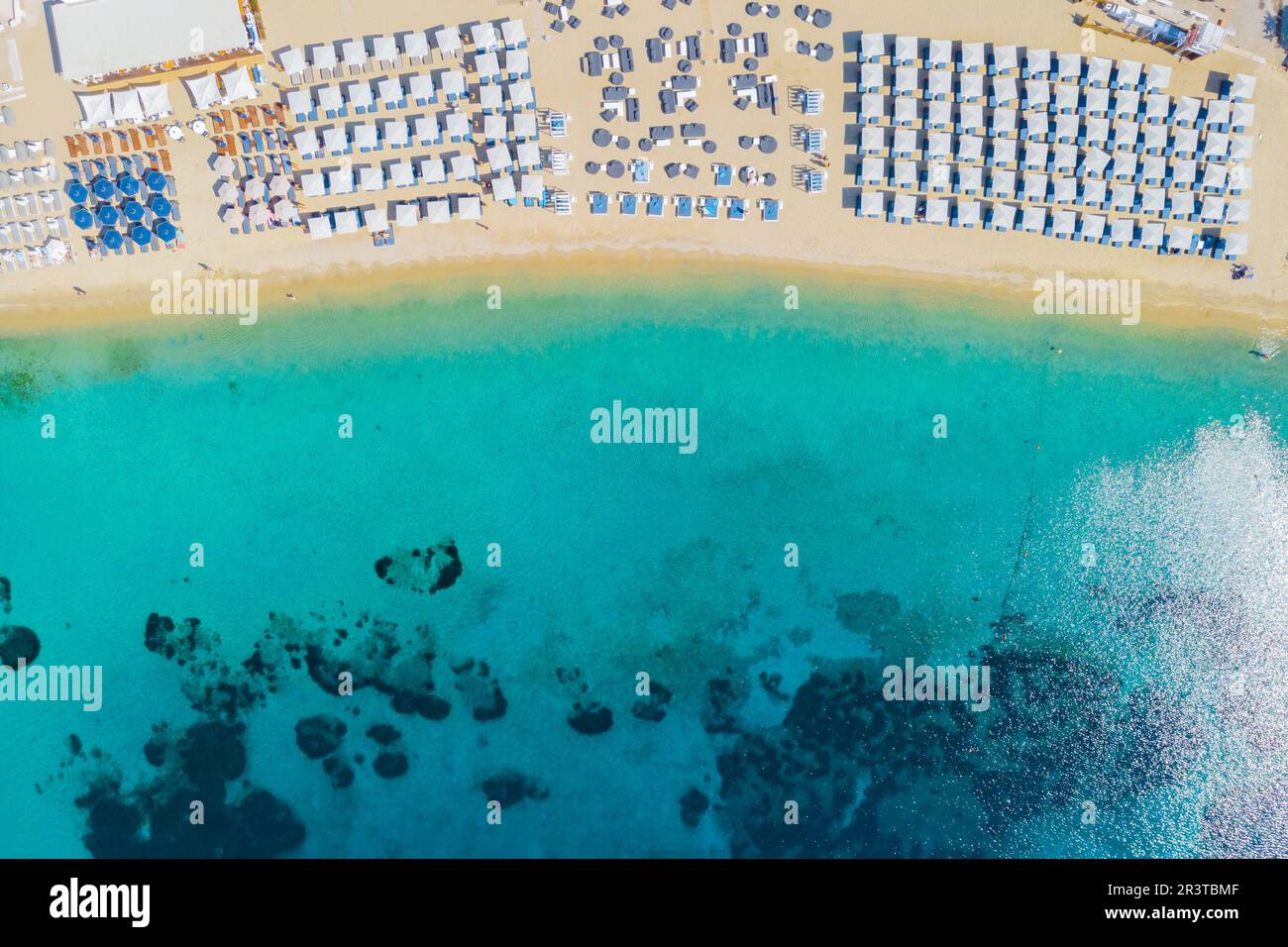 Mykonos beach during summer with umbrella and luxury beach chairs beds