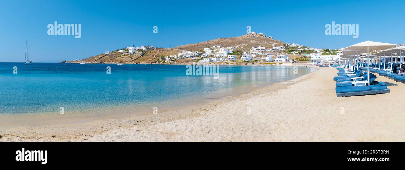 Mykonos beach during summer with umbrella and luxury beach chairs beds