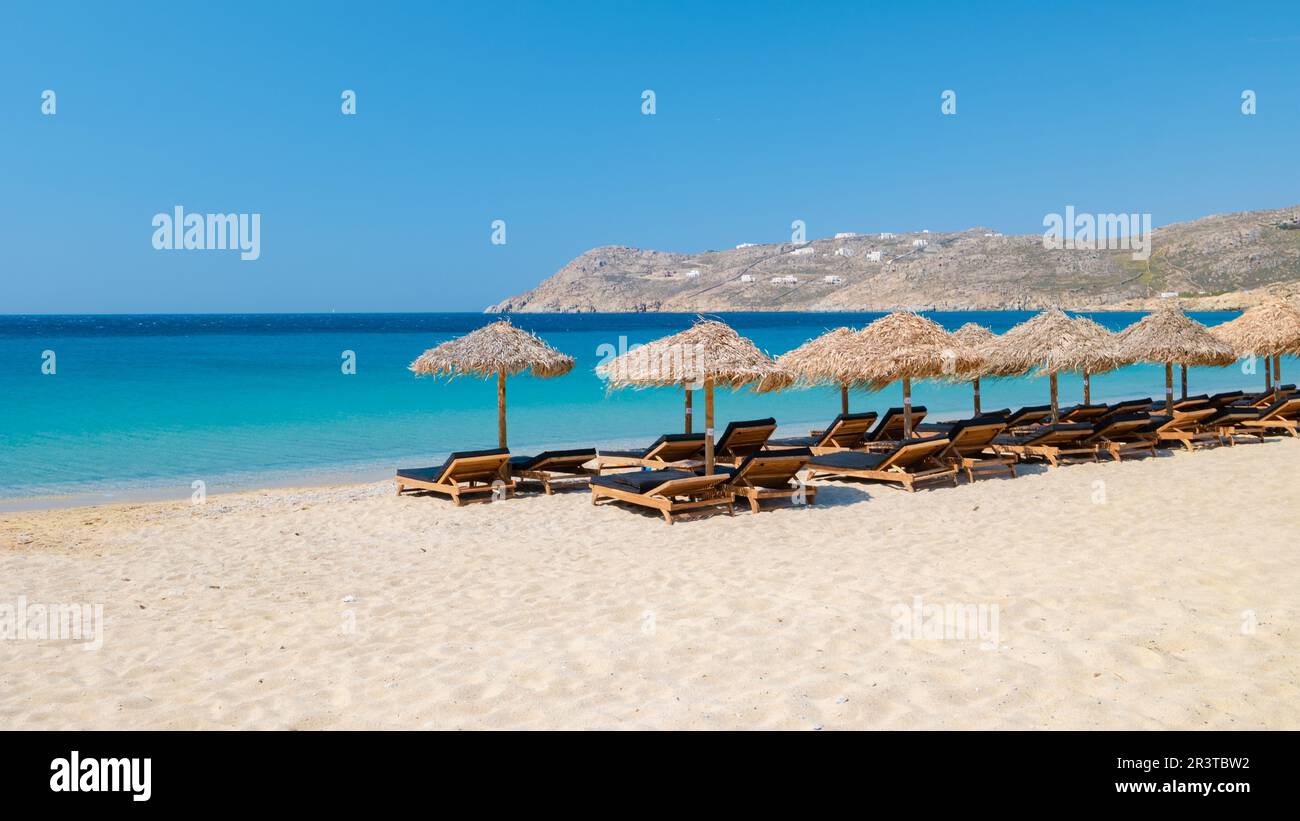 Mykonos beach during summer with umbrella and luxury beach chairs beds