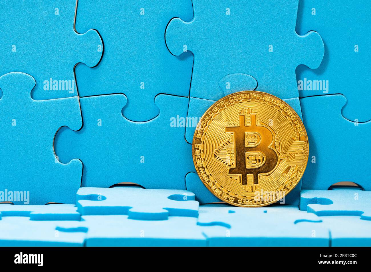 Golden Bitcoin with a blue puzzle Stock Photo - Alamy