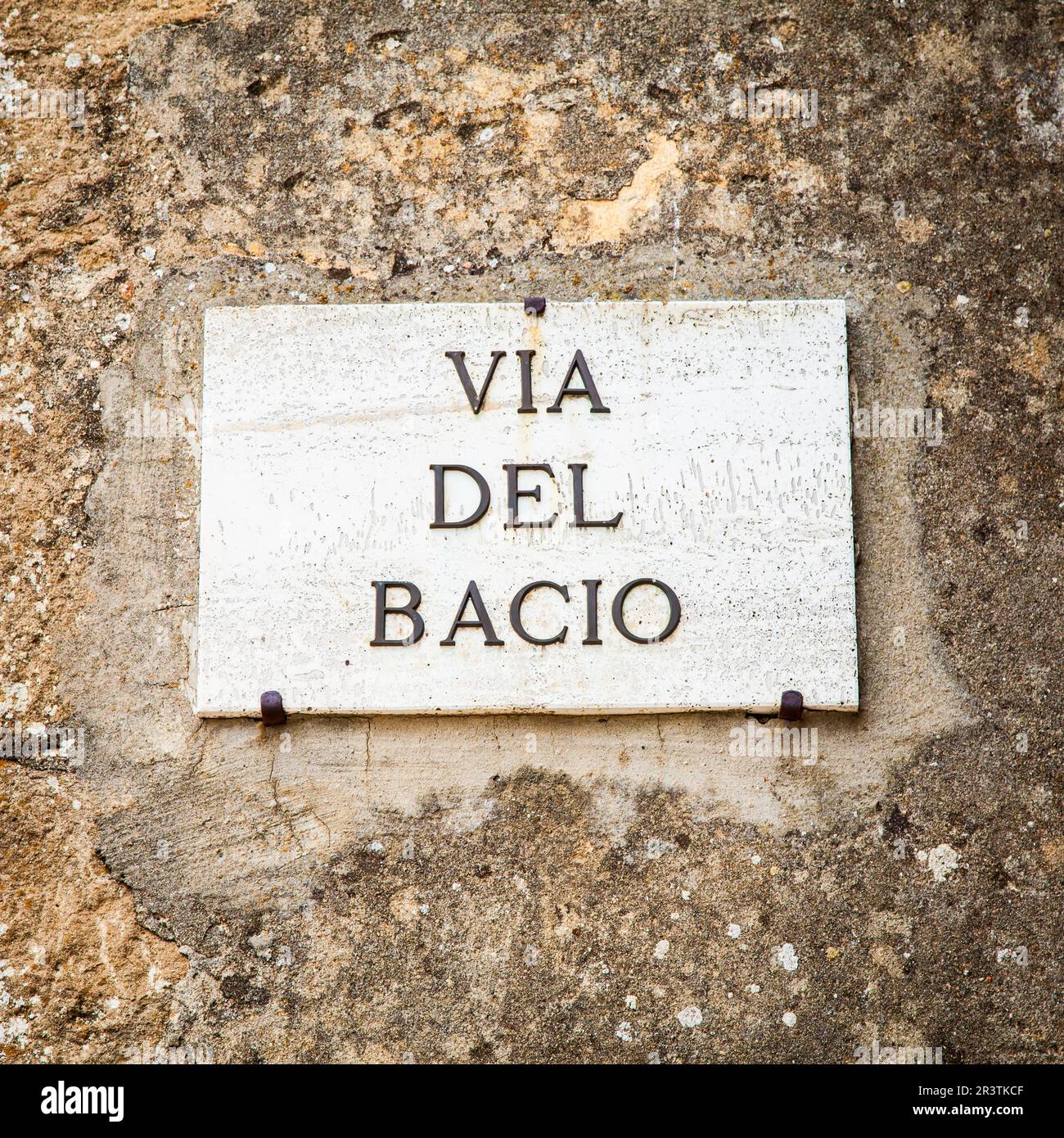 Italy - Pienza town. The streetsign of Via del Bacio (Kiss Street) Stock Photo