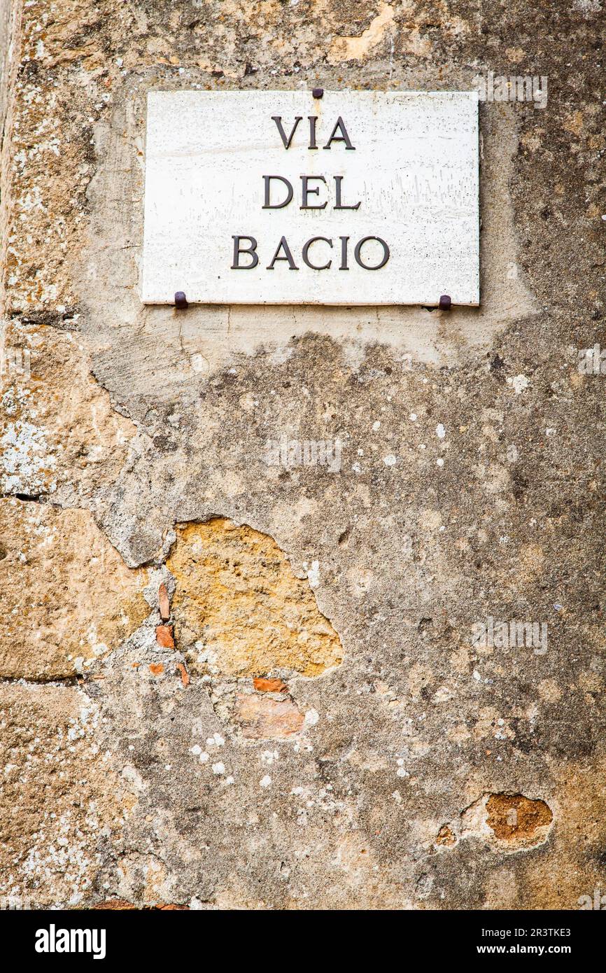 Italy - Pienza town. The streetsign of Via del Bacio (Kiss Street) Stock Photo