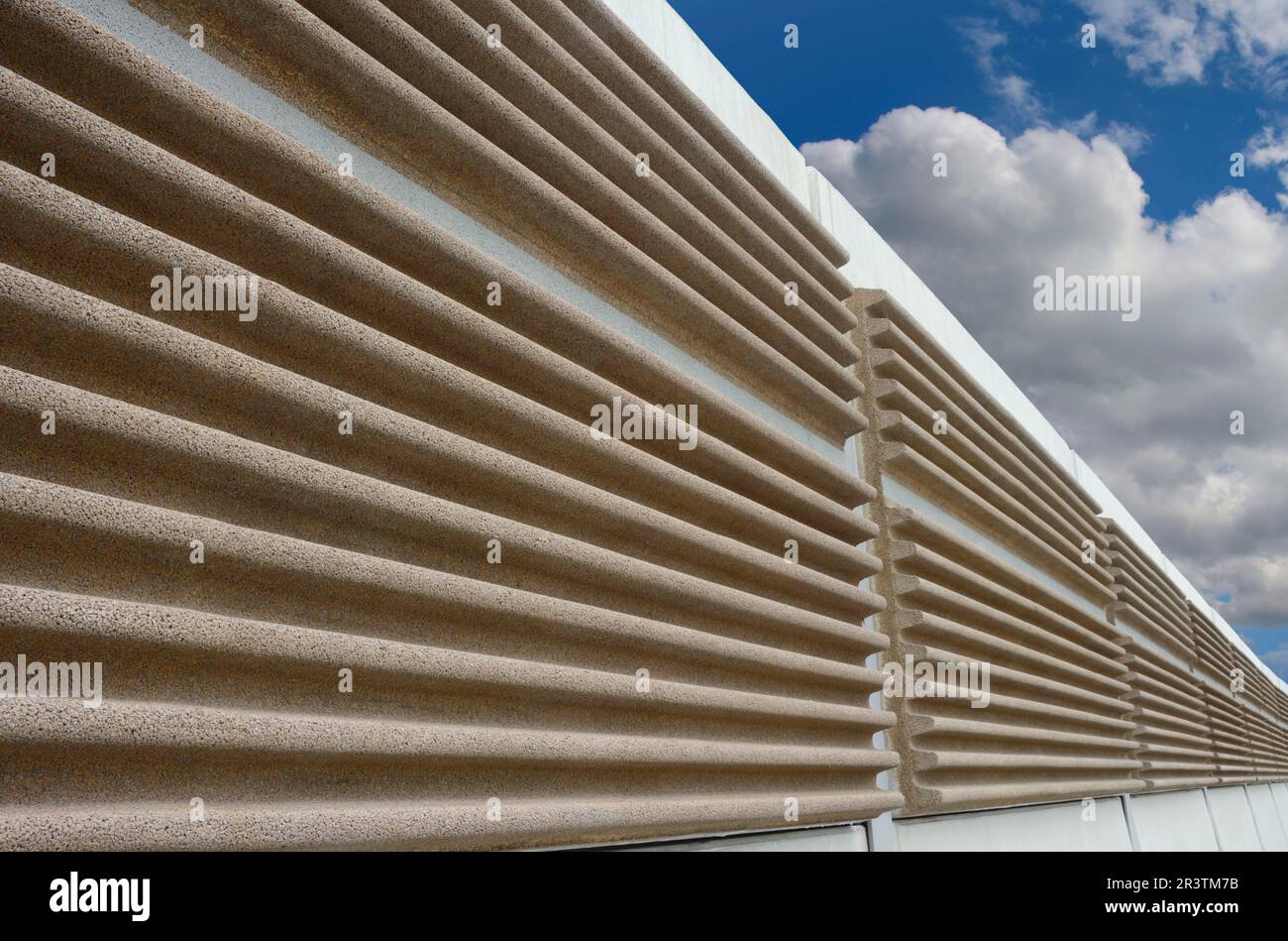 A modern soundproof wall with cloudy sky in background Stock Photo
