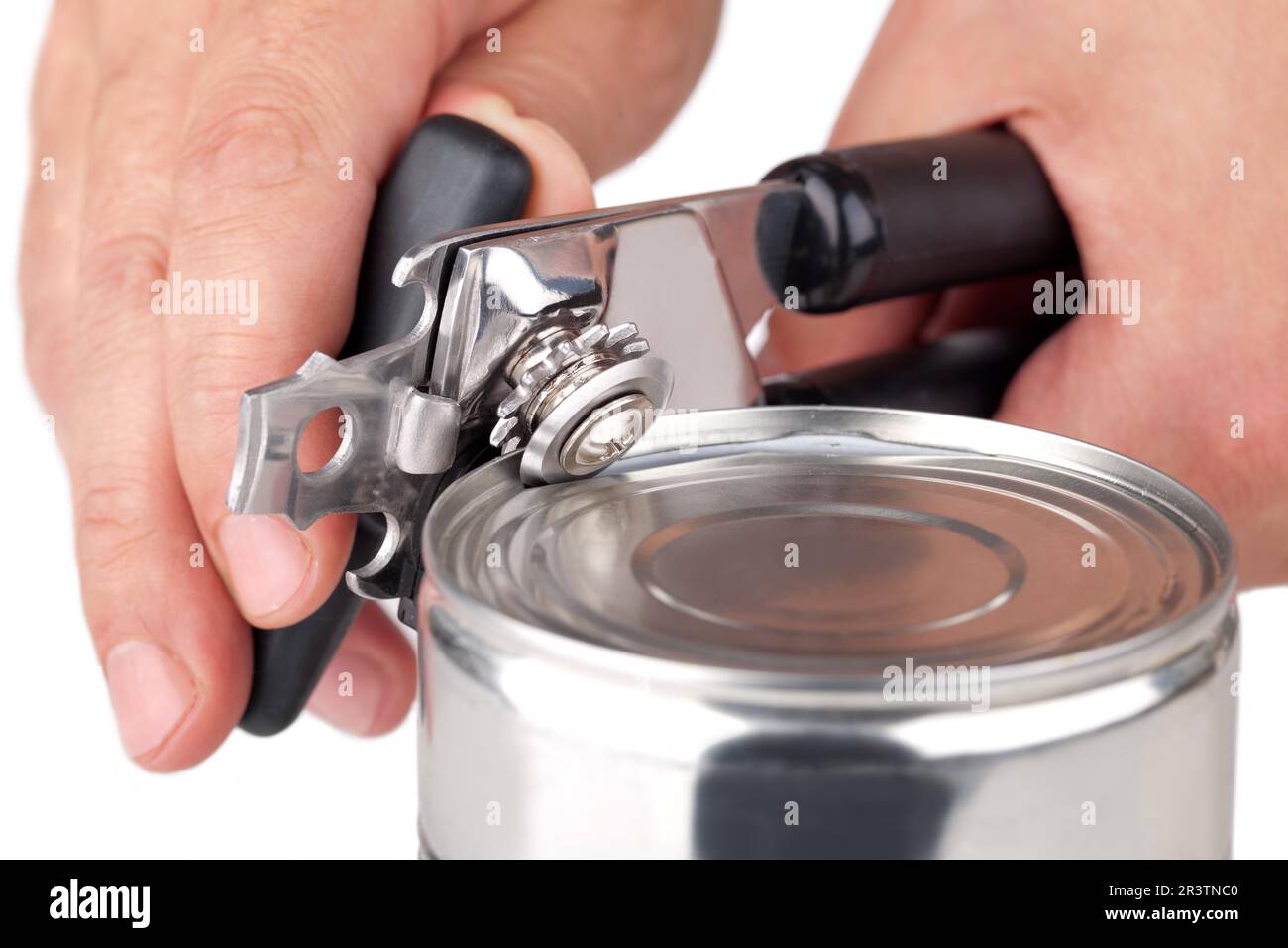 Tin opener opening a can Stock Photo - Alamy