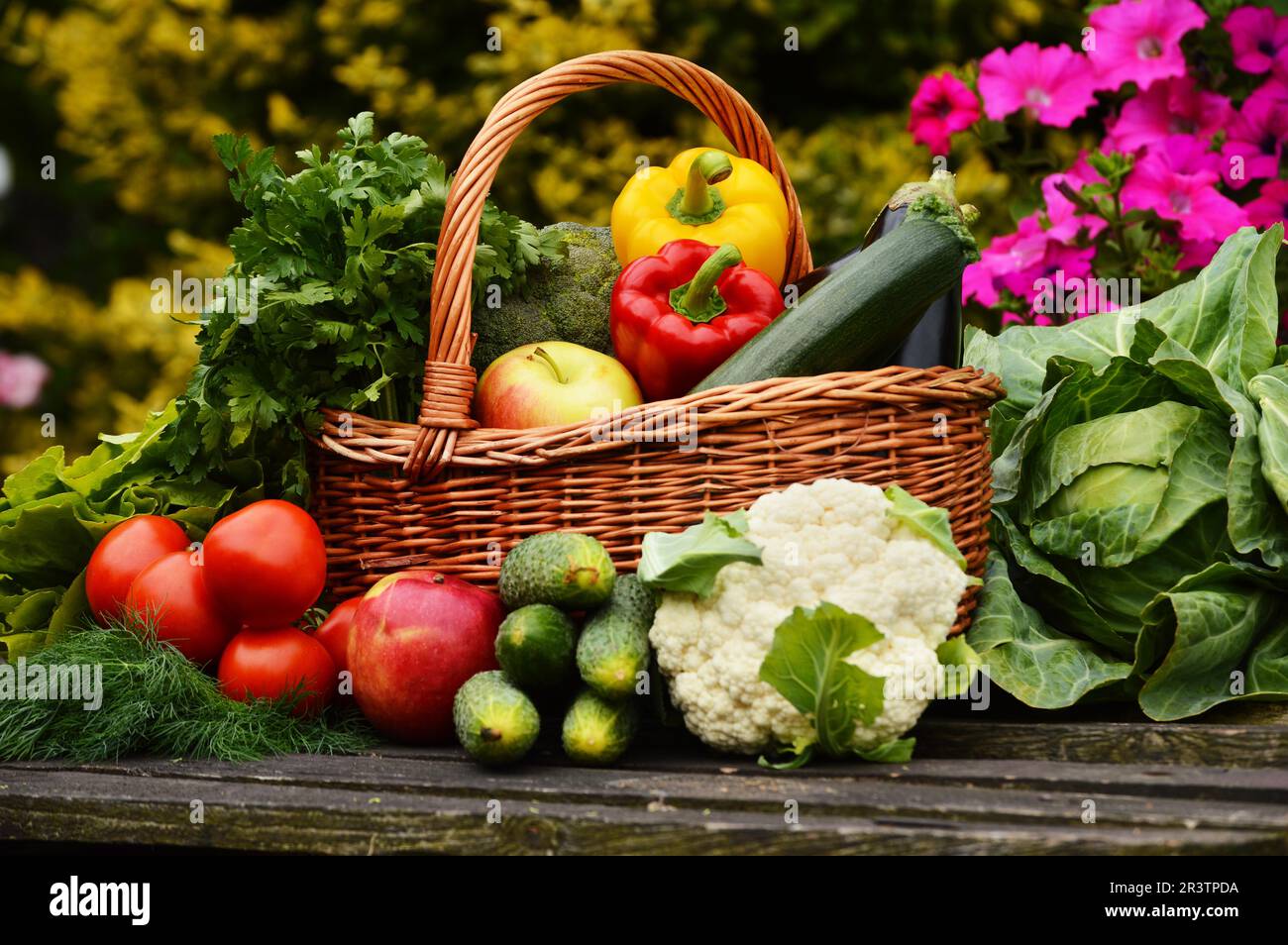 Fresh organic vegetables in wicker basket in the garden Stock Photo - Alamy