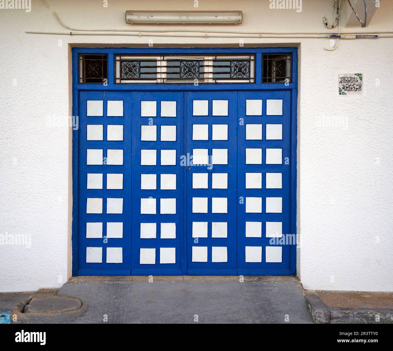 Mahdia, Tunesia, January 29, 2023: Geometric abstract blue and white painted front door in a Tunisian house Stock Photo