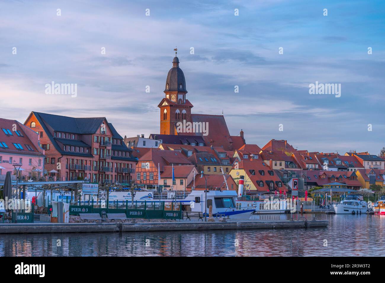 City harbour with motor boats, Waren, St. George's Church, evening light, sky, old town, redevelopment, Mecklemburg Lake District Stock Photo