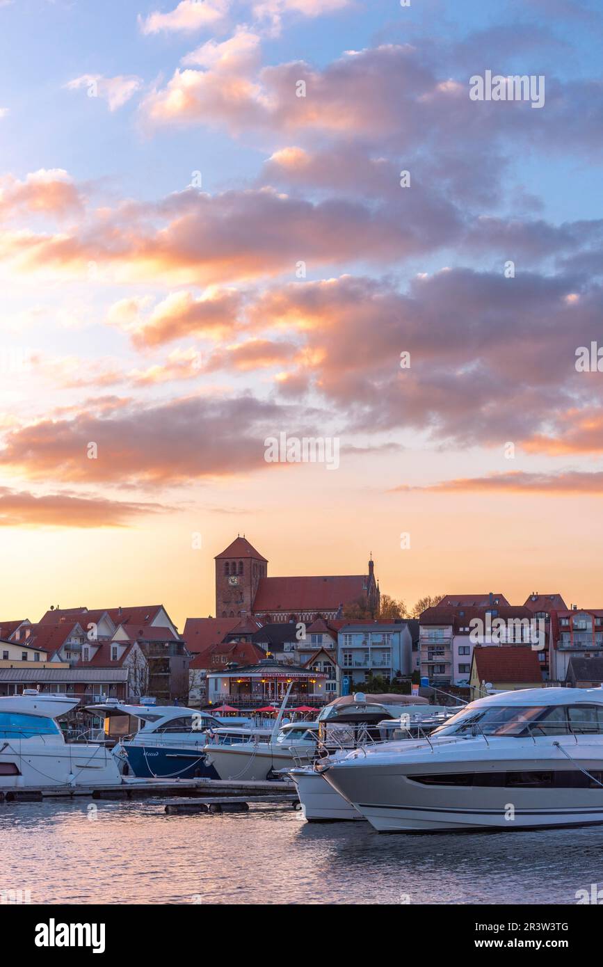 City harbour with motor boats, Waren, St. George's Church, evening light, sky, old town, portrait format, Mecklemburg Lake District Stock Photo