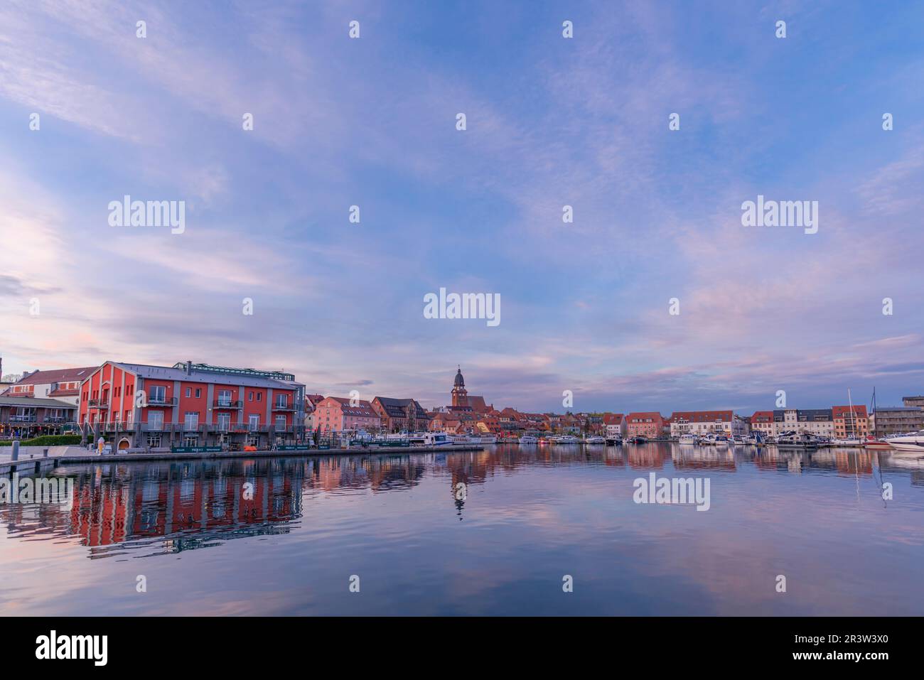 City harbour with motor boats, Waren, St. George's Church, panorama, evening light, sky, water reflection, old town, Mecklemburg Lake District Stock Photo