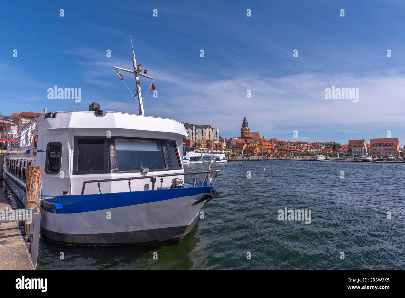 City harbour with motor boats, Waren, St. George's Church, evening light, sky, old town, excursion boat, Mecklemburg Lake District Stock Photo