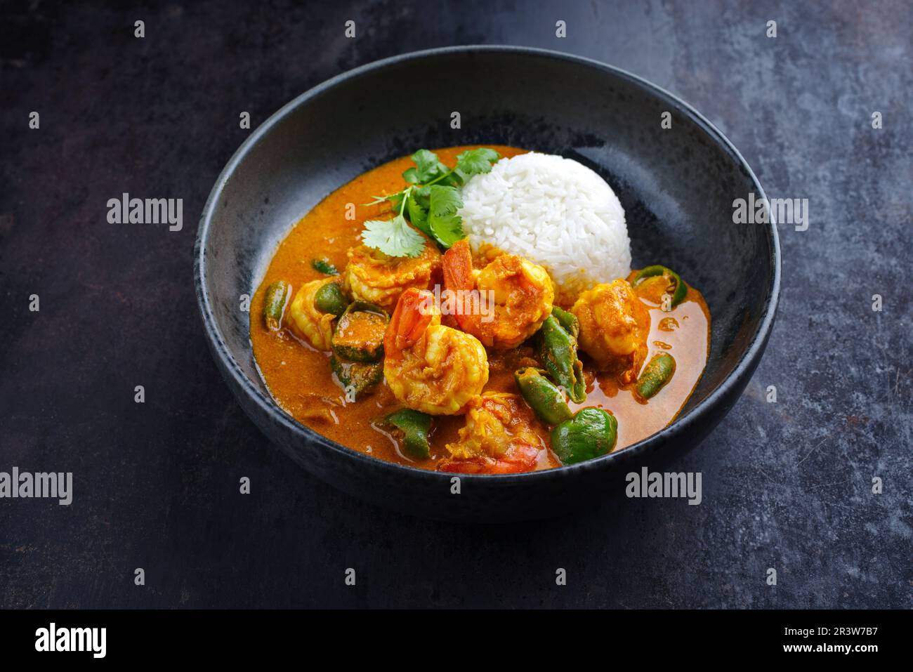 Traditional Thai kaeng phet red curry with chili and basmati rice served as close-up in a Nordic design bowl Stock Photo