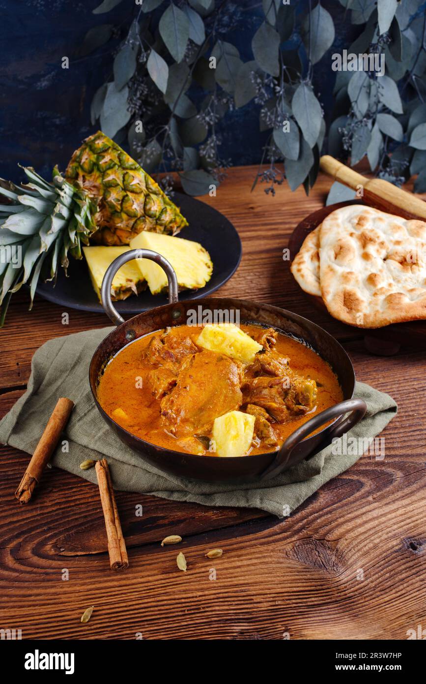 Traditional spicy Indian chicken Madras curry Rogan Josh with drumsticks Stock Photo