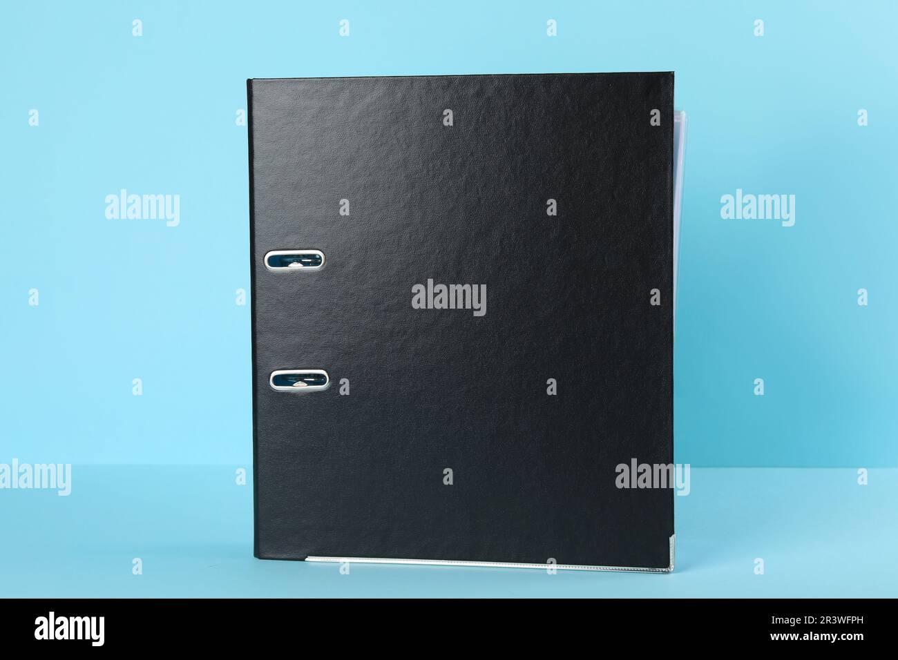 Black hardcover office folder on light blue background Stock Photo