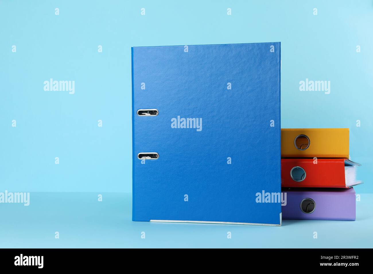 Hardcover office folders on light blue background Stock Photo