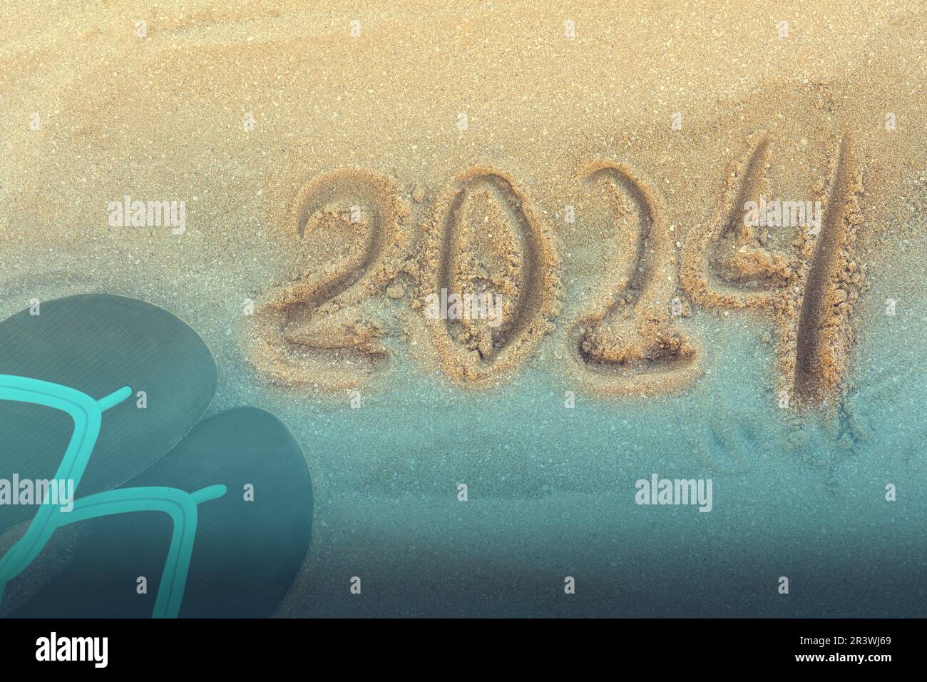 Happy New Year 2024, lettering message handwritten on the beach Numbers
