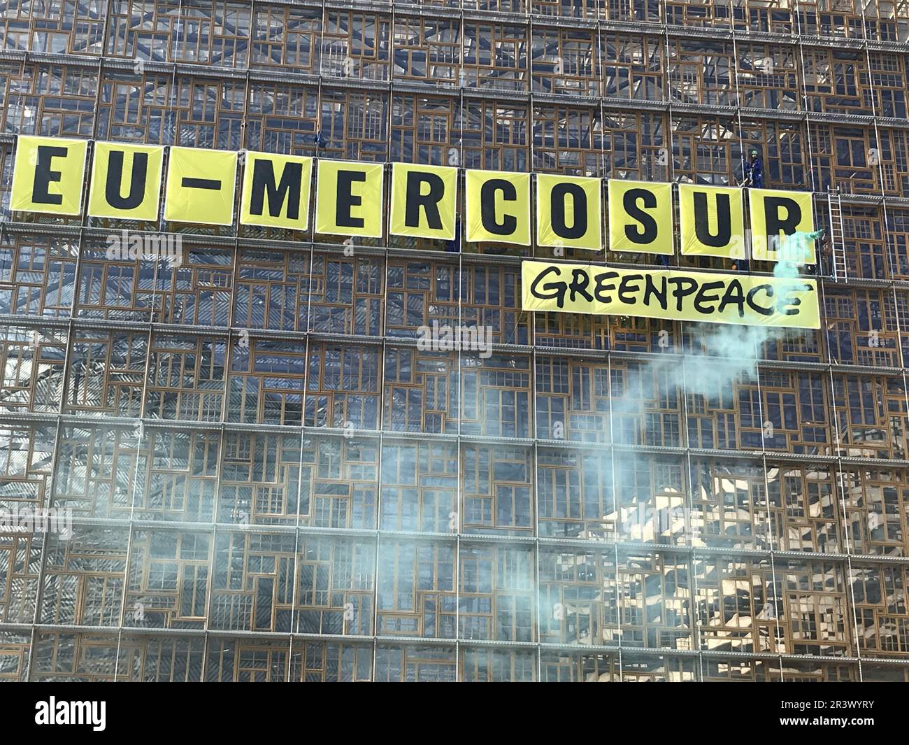 Illustration picture shows a banner saying 'Stop EU-Mercosur' during a protest action of Greenpeace environmental activists at the European Council building, Thursday 25 May 2023, in Brussels. Greenpeace activists gathered to protest against the proposed trade agreement between the EU and four South American Mercosur countries (Argentina, Brazil, Paraguay and Uruguay). For the NGO, the text conflicts with the European Green Deal. Greenpeace is particularly concerned about the different sanitary standards between the partners, especially concerning European pesticides, some of which are banned Stock Photo