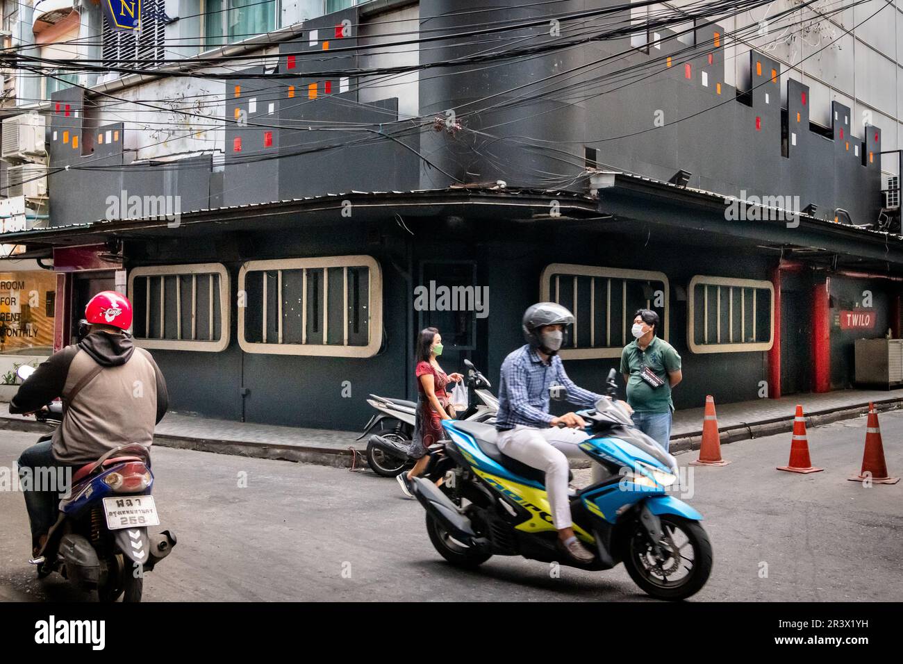 A view of Soi 2 Patpong showing the gogo bar Bada Bing. People & traffic passing along this famous little street in the Bangkok red light district. Stock Photo