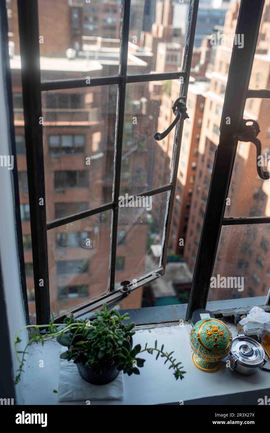 Manhattan buildings viewed through open old fashioned apartment window ...