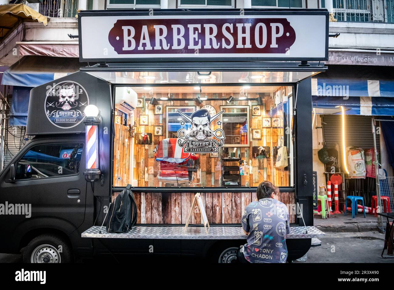 A mobile barber shop set up in Soi 1 Patpong Bangkok Thailand. Stock Photo