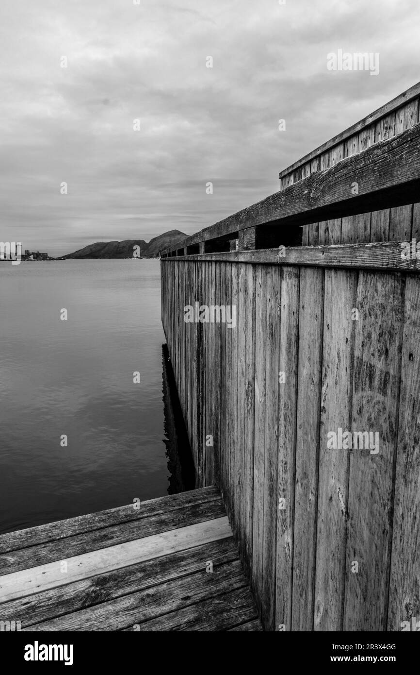 Sandnes, Norway, May 18 2023, Abstract Black And White Monochrome Image Wooden Dock Board Walk Structure At Waters Edge Stock Photo