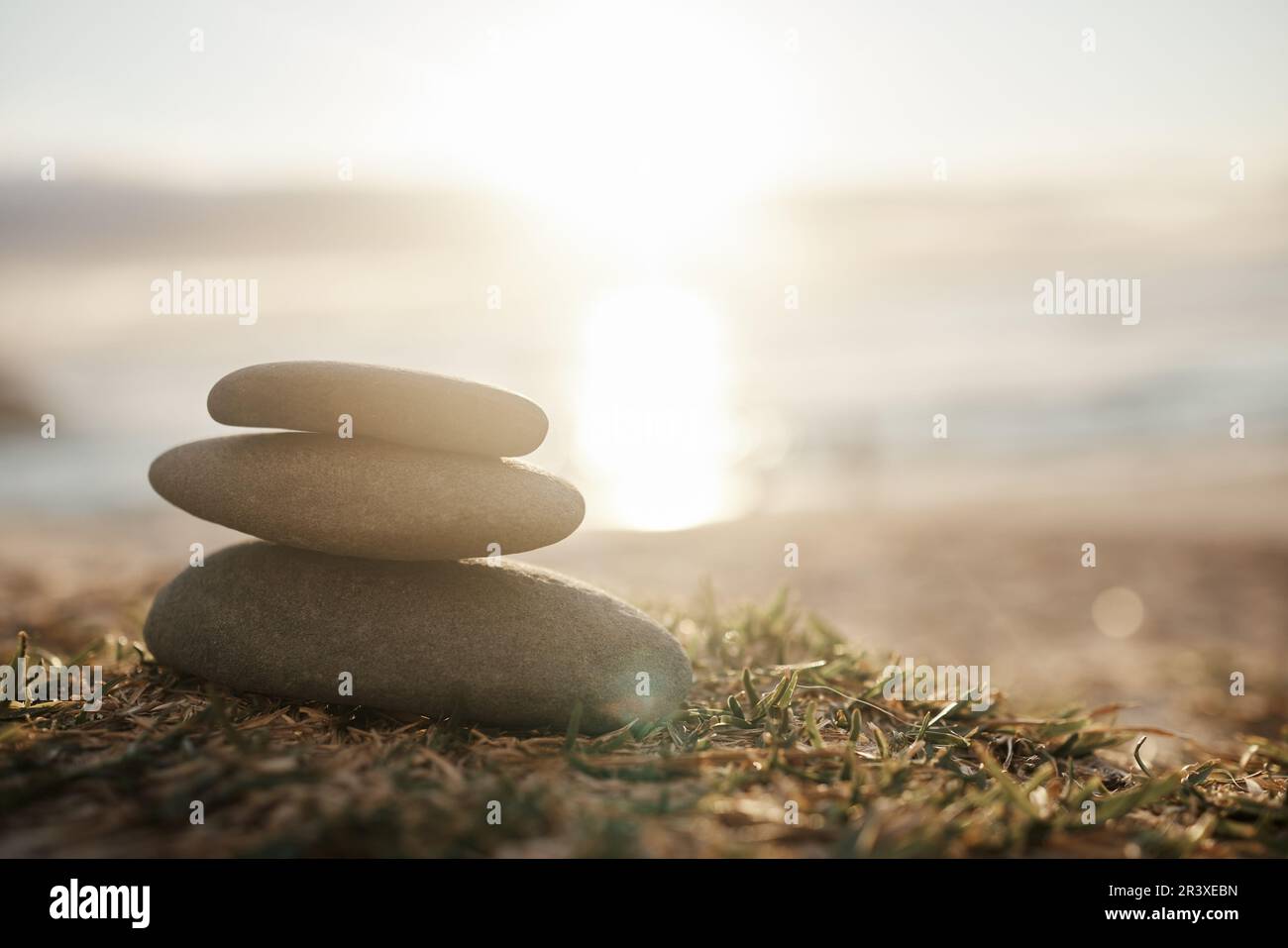 Nature, calm and rocks on the beach grass for peace, balance and zen at ...