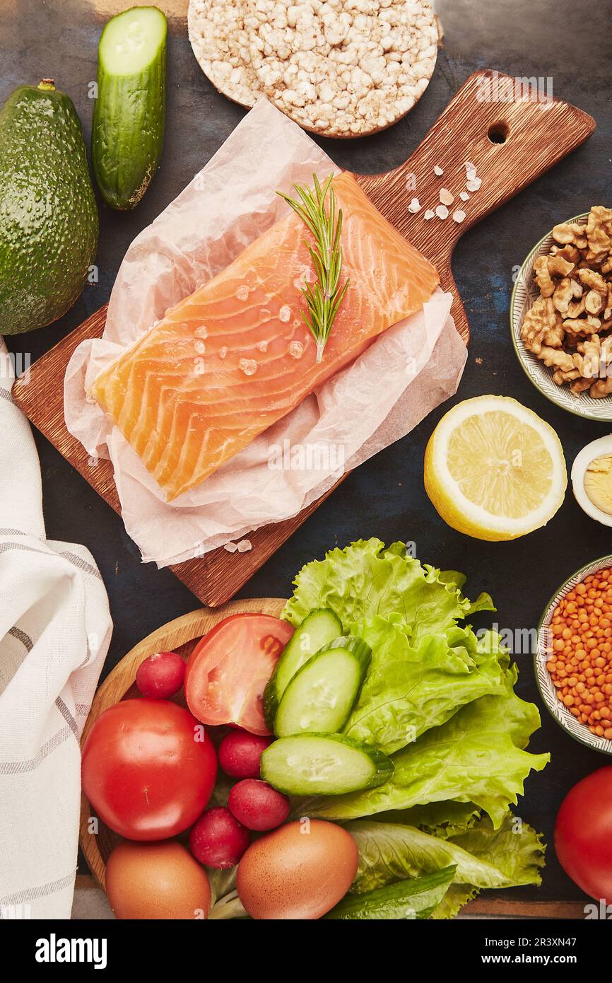 Ketogenic, Paleo, FODMAP diet concept. Fruits,vegetables, smoked salmon, greens, eggs background. Stock Photo