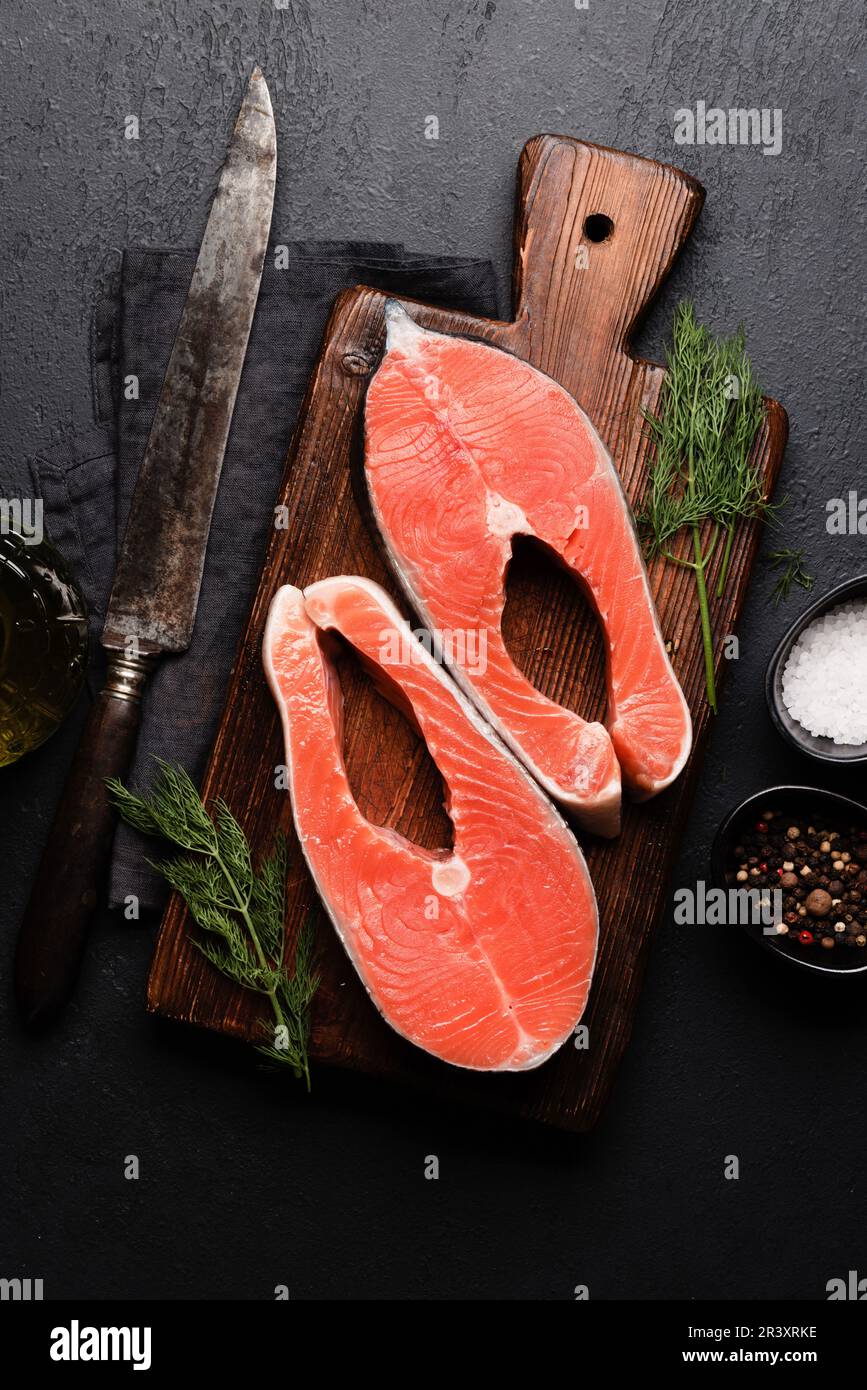 Fresh salmon steak. Two raw fish steaks and spices. Flat lay Stock ...