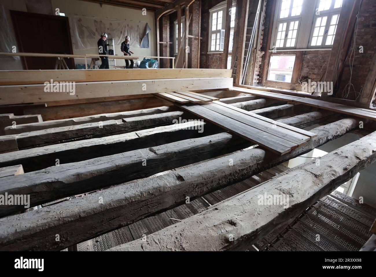 25 May 2023, Saxony-Anhalt, Wernigerode: View into the gutted large ballroom of the Wernigerode town hall. The historic town hall is currently being renovated in accordance with the preservation order. In the area of the hall, considerable vibrations of the floor were noticed. When the ceiling below was opened, it was found that the existing construction (spacing and span of the ceiling beams) was too weak for the intended use. Therefore, a structural reinforcement of the ceiling beams is mandatory. The implementation of the necessary construction measures is to be carried out in five individu Stock Photo