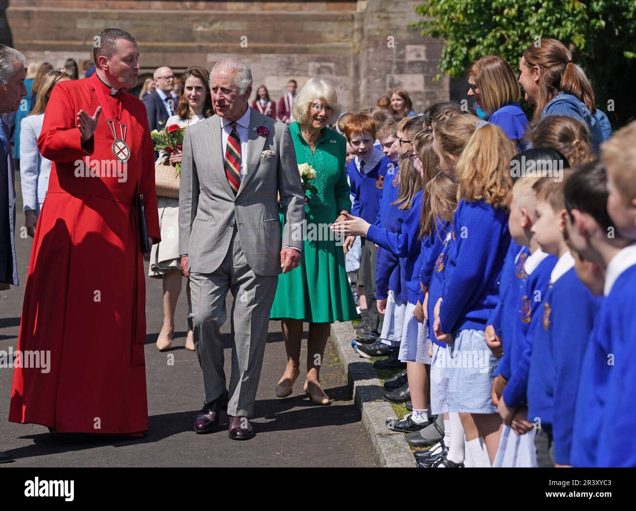 King Charles III and Queen Camilla with the Dean of Armagh, the Very Revd Shane Forster (left) with children from Armstrong primary school Armagh outside St Patrick's Cathedral in Armagh, Co Armagh, during their two day visit to Northern Ireland. Picture date: Thursday May 25, 2023. Stock Photo