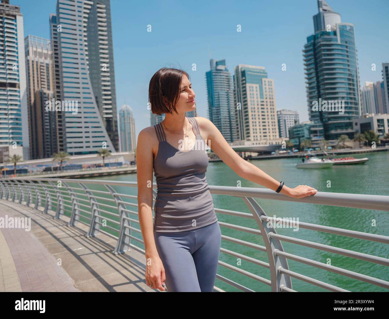 City Running asian woman runner , Dubai marina urban scene in