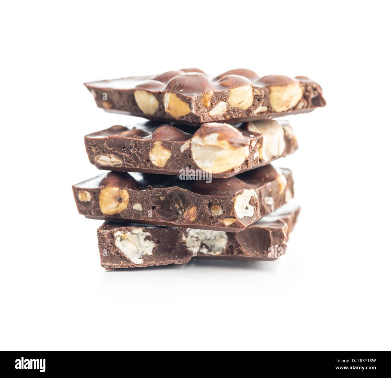 Broken chocolate bars with  nuts isolated on the white background. Stock Photo