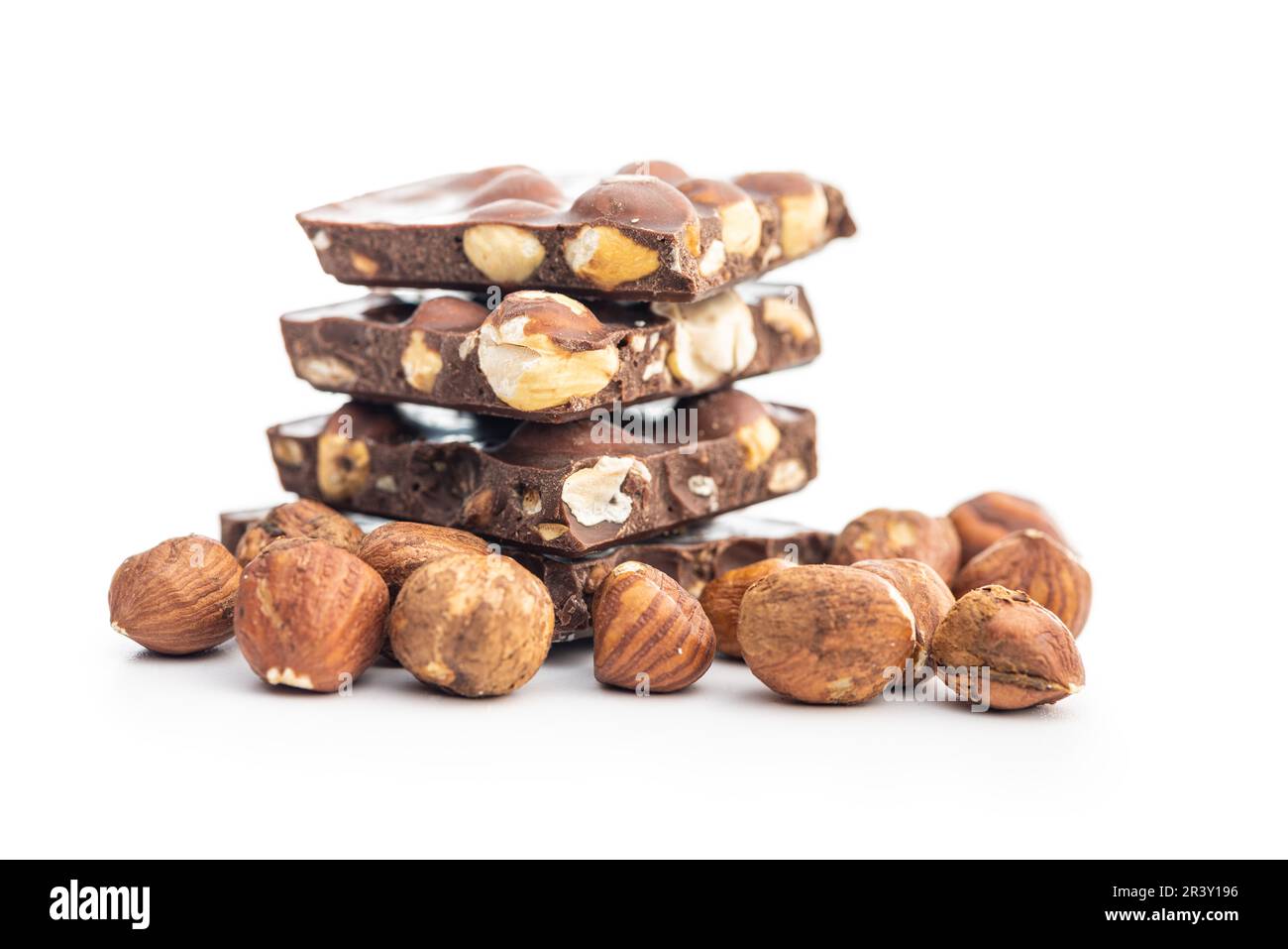 Broken chocolate bars with  nuts isolated on the white background. Stock Photo