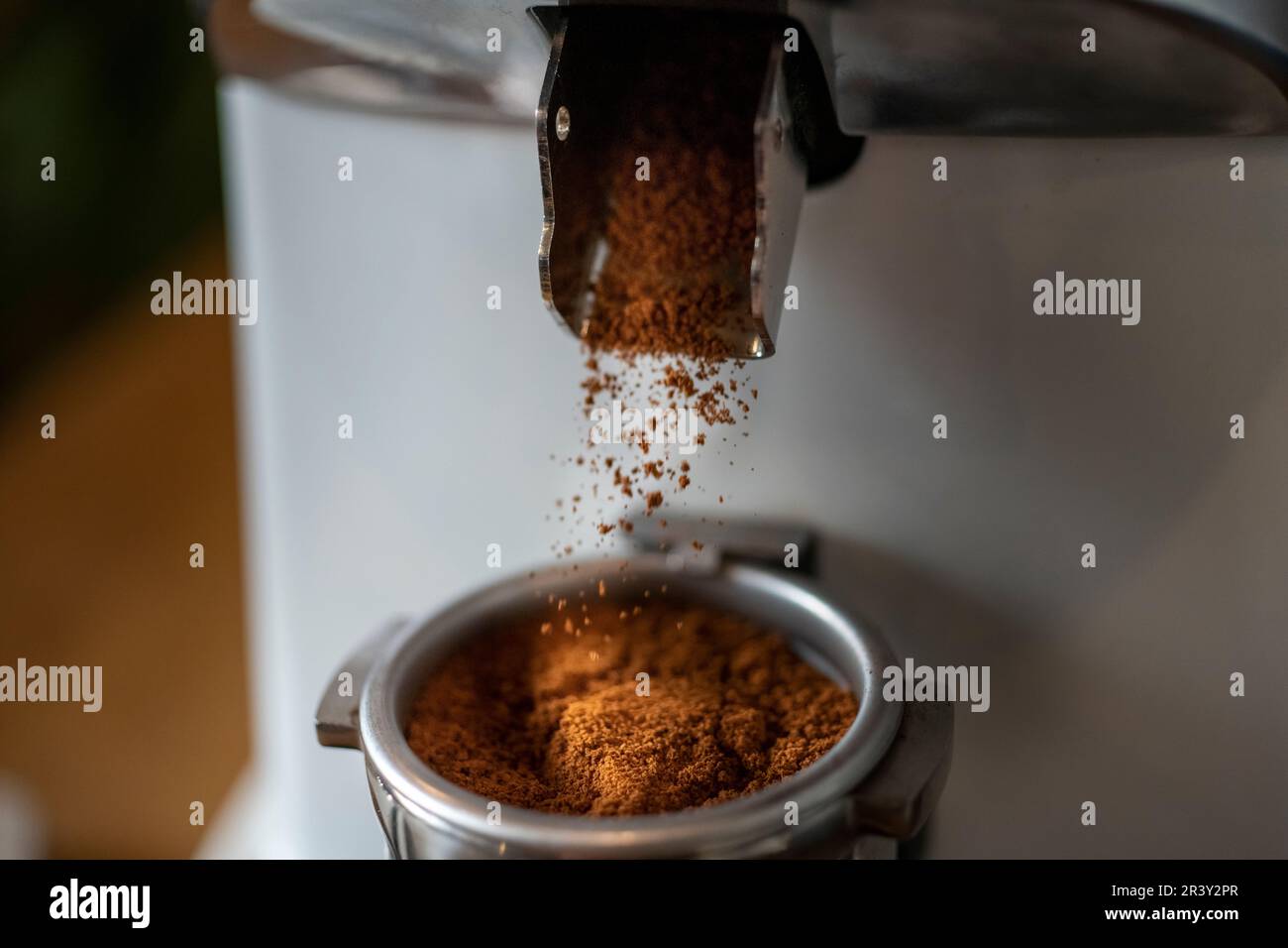 Coffee prep, the home Barista making Espresso using a Grinding Machine