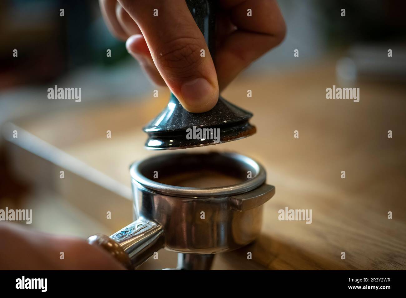 Coffee prep, the home Barista making Espresso using a Grinding Machine Coffee extraction and using the hopper, closer detail shots Stock Photo