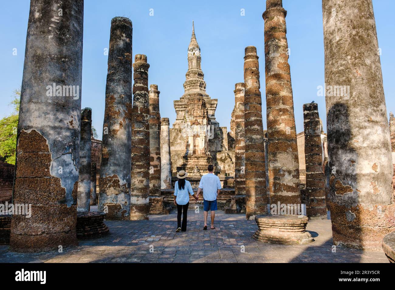 Asian women and Caucasian men visiting Wat Mahathat, Sukhothai Thailand. Sukothai historical park Stock Photo