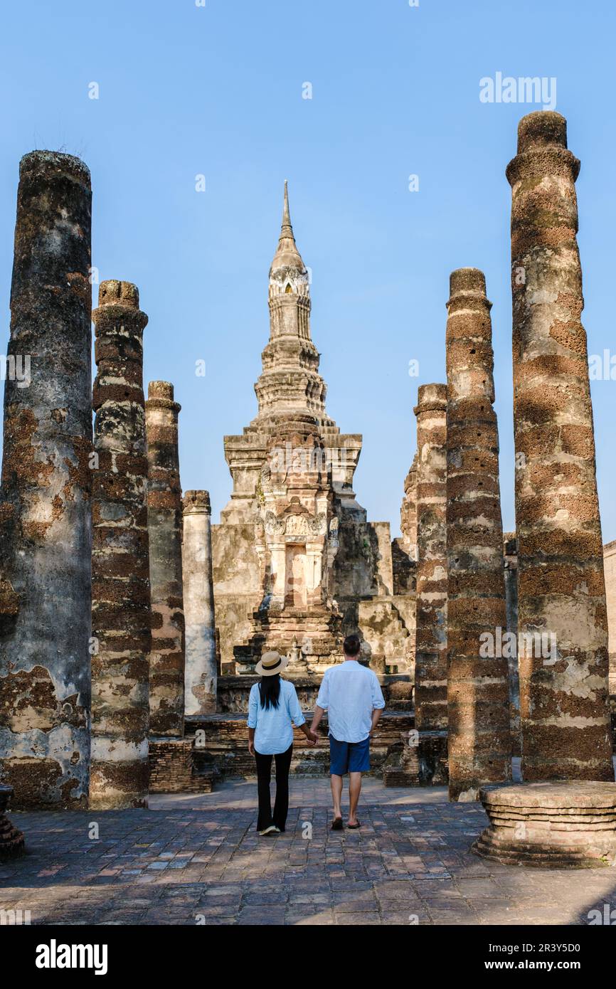 Asian women and Caucasian men visiting Wat Mahathat, Sukhothai Thailand. Sukothai historical park Stock Photo