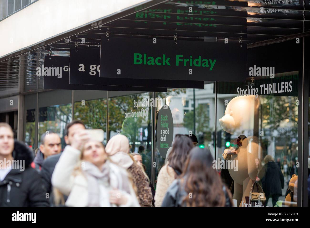 Black Friday logos are seen displayed outside a store in London ahead