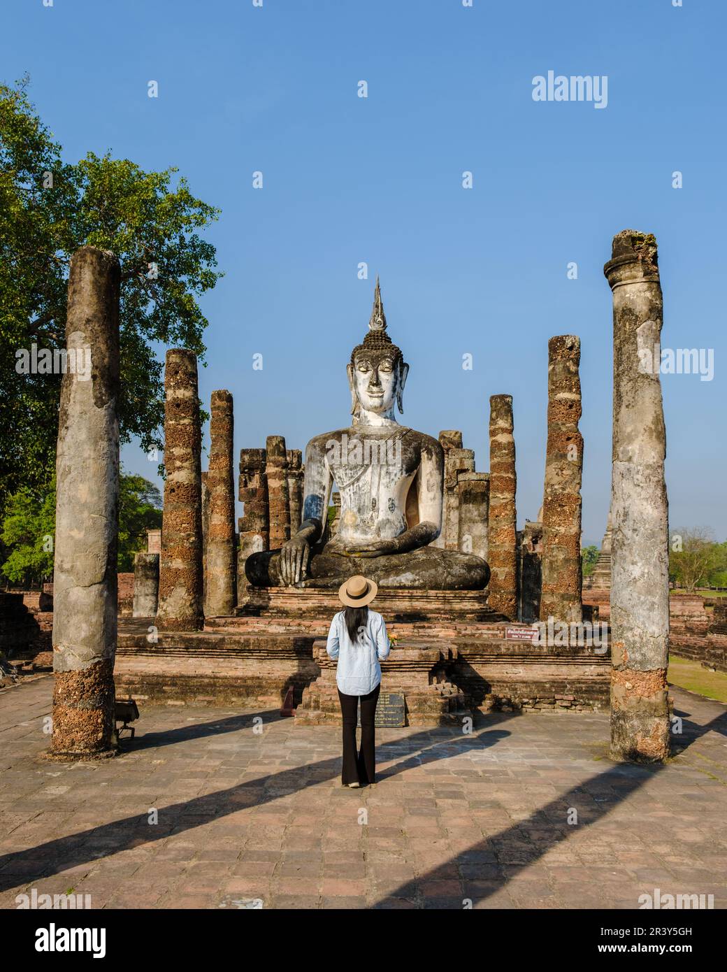 Women visit Wat Mahathat, Sukhothai old city, Thailand. Sukothai historical park Stock Photo