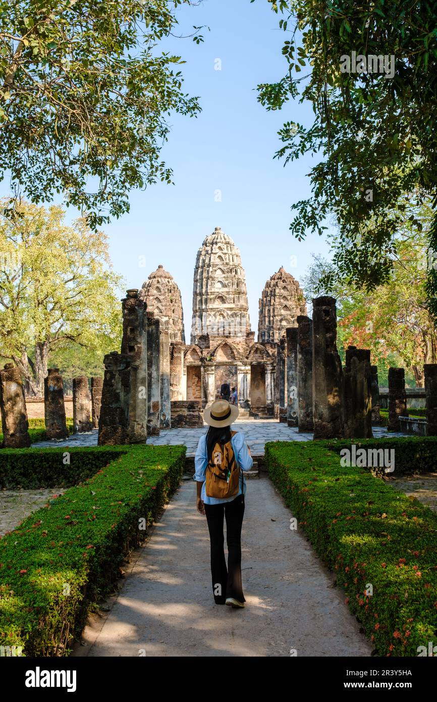 Asian women visiting Wat Si Sawai, Sukhothai old city, Thailand. Sukothai historical park Stock Photo