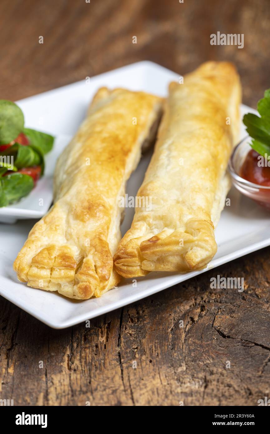Frankfurter in puff pastry with salad Stock Photo