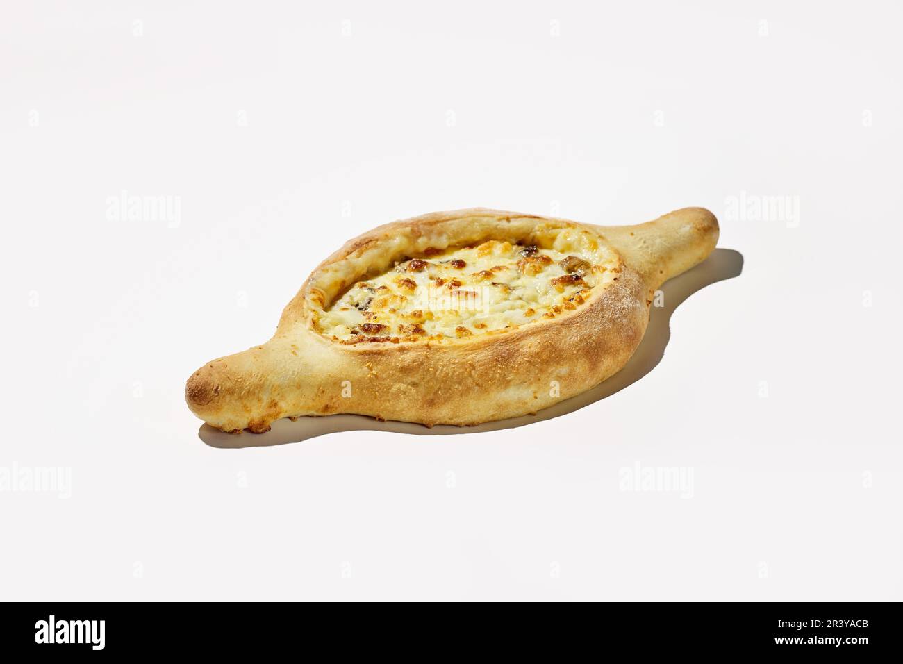 Adjarian khachapuri on white background. An unconventional version of Georgian cuisine, dough boat with cheese and meat Stock Photo