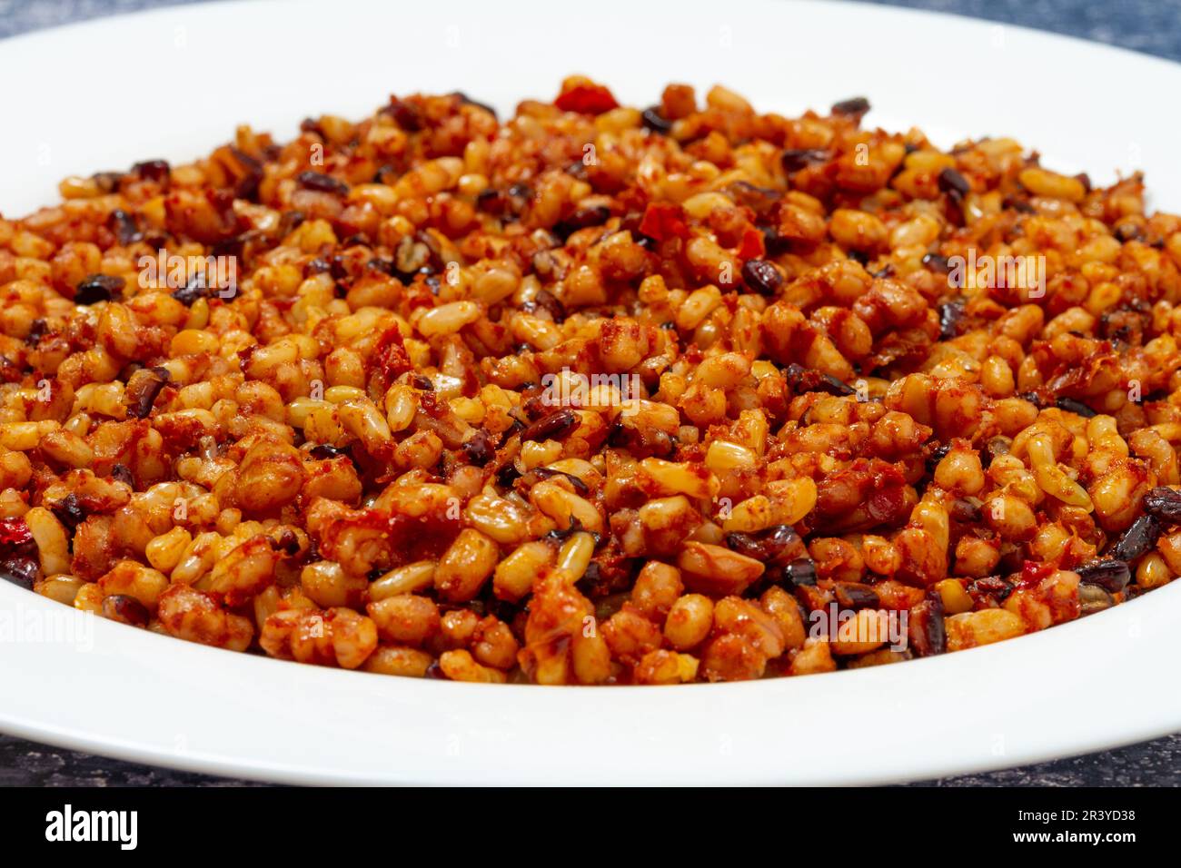 plated Spanish style grains; rice, red pepper and paprika Stock Photo