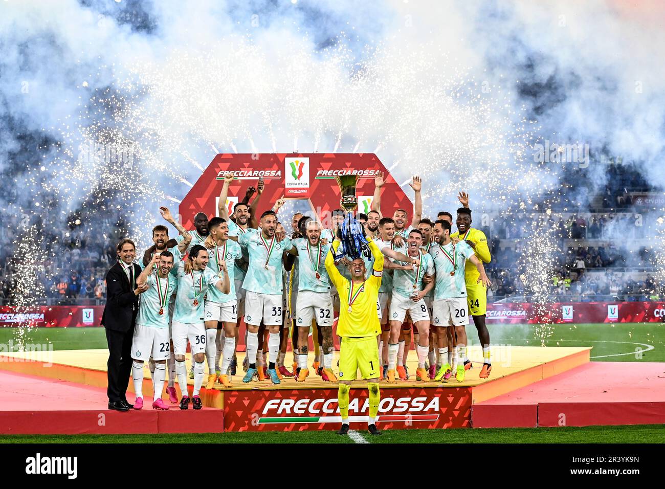 Samir Handanovic of Fc Internazionale lifts the trophy as he celebrates with teammates and with Simone Inzaghi, head coach, the victory at the end of Stock Photo