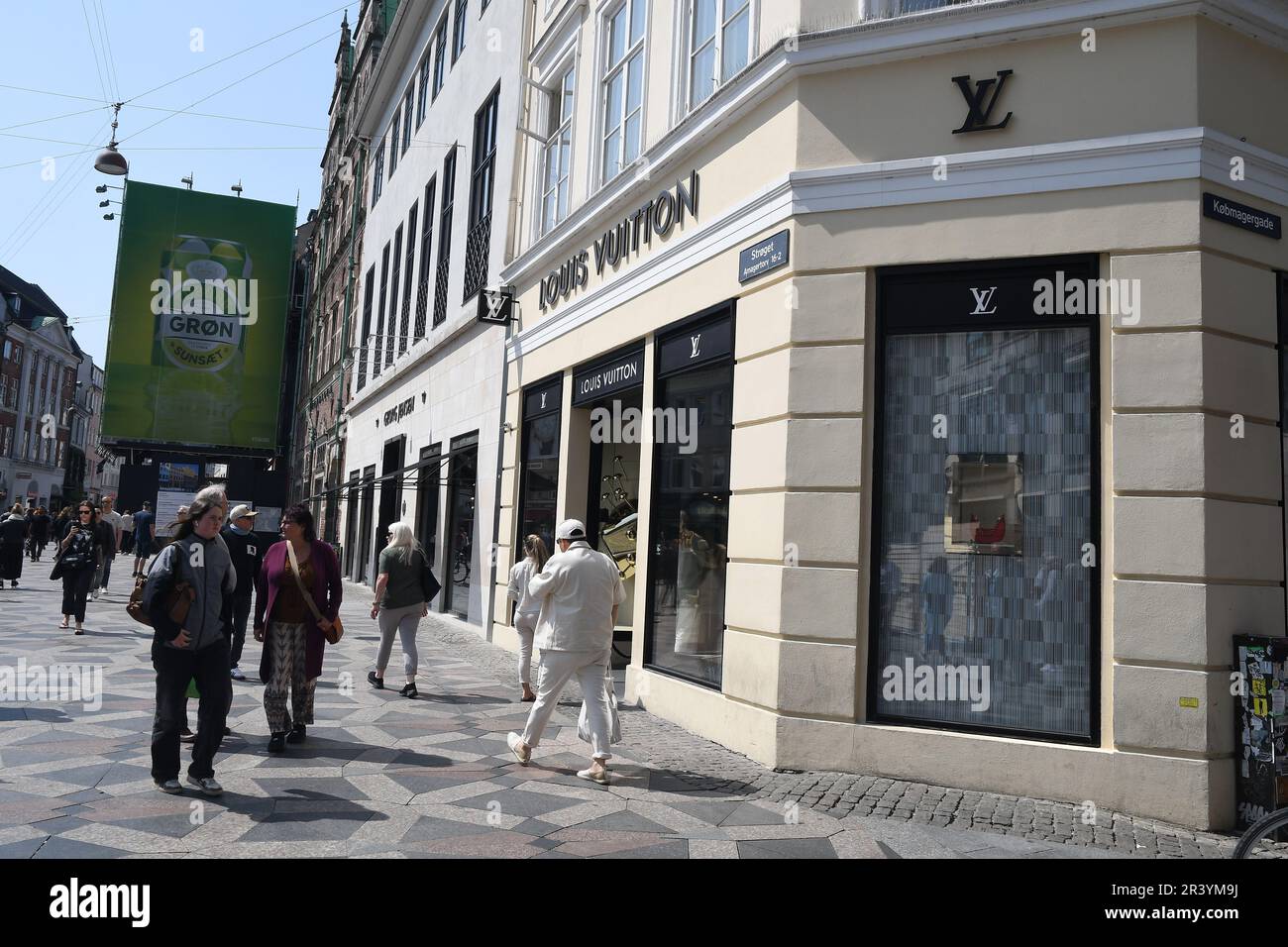 25 May 2023/ Consumers wait at Louis Vuitton store in danish capital  Copenhagen on stroeget pedestrain stree. (Photo.Francis Joseph Dean/Dean  Pictures Stock Photo - Alamy