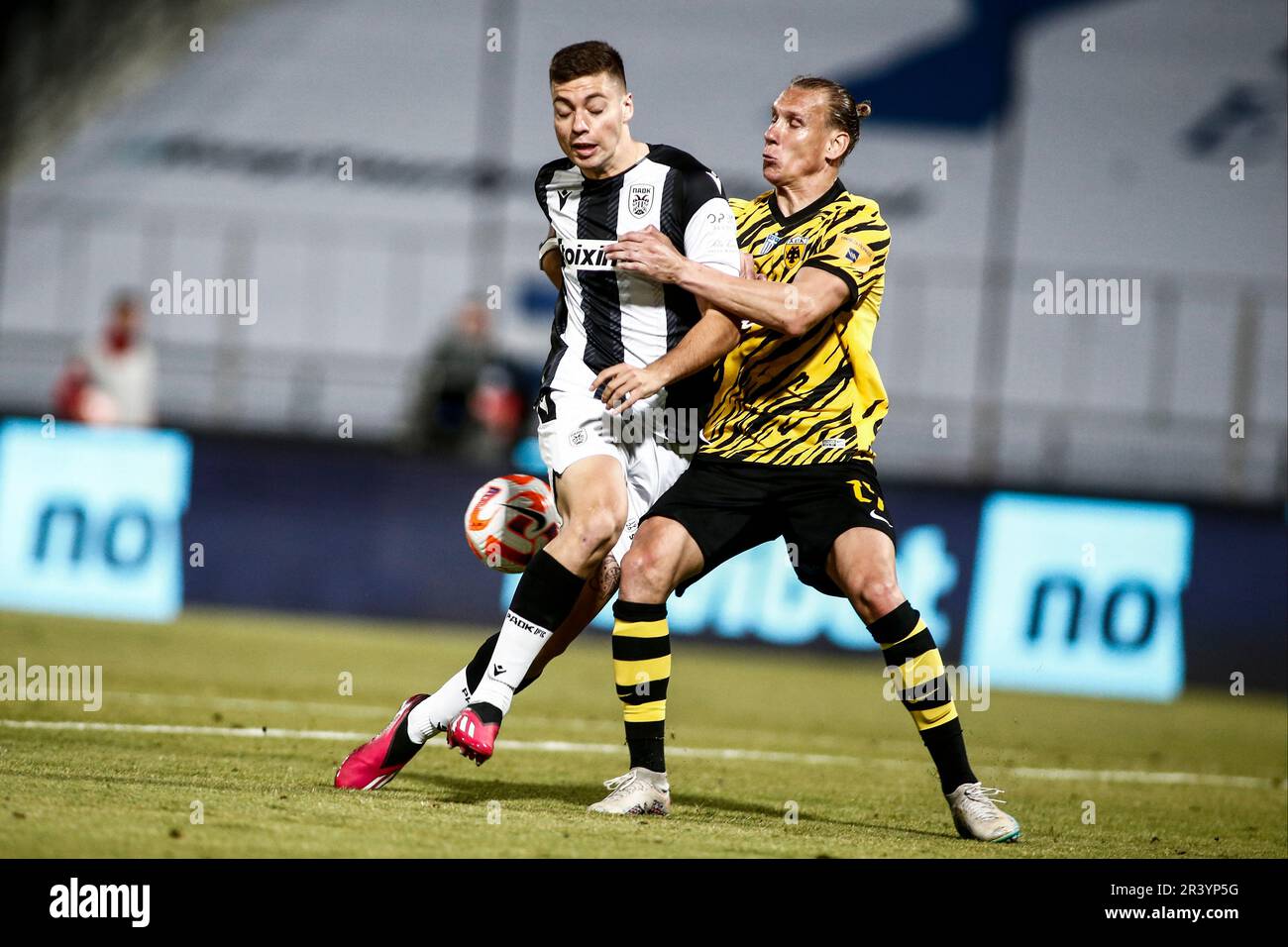 Volos, Greece. 24th May, 2023. AEK's player Domagoj Vida (Right) and PAOK's  Stefanos Tzimas (Left) fight for the ball in action during the final of the  Greek soccer Cup. AEK FC won