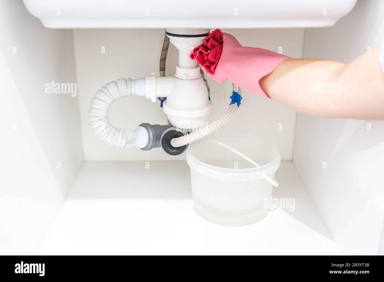 Leakage Of Water From plastic Pipe under sink in laundry room Stock