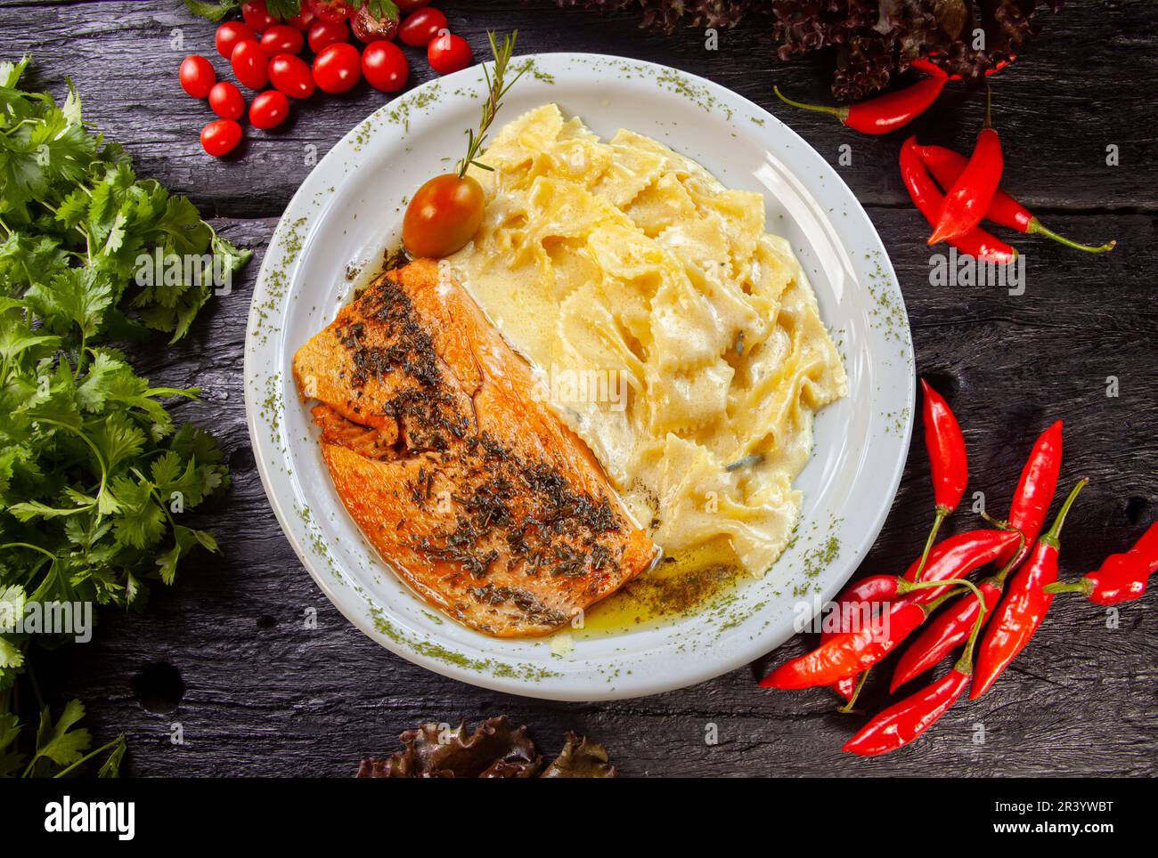Pasta with white sauce and grilled salmon Stock Photo - Alamy