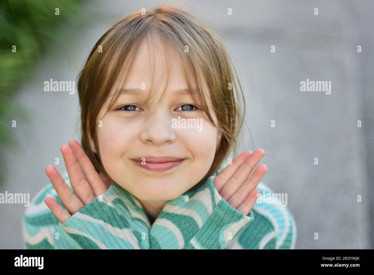 Close up face portrait of beautiful cute blonde young girl posing with confidence Stock Photo